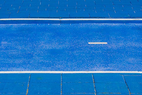 A blue swimming pool with a white line
