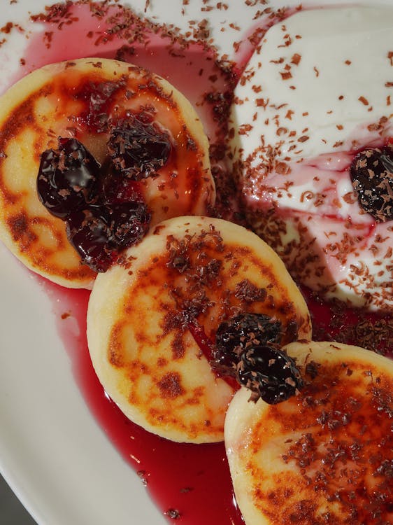 A white plate topped with pancakes and berries