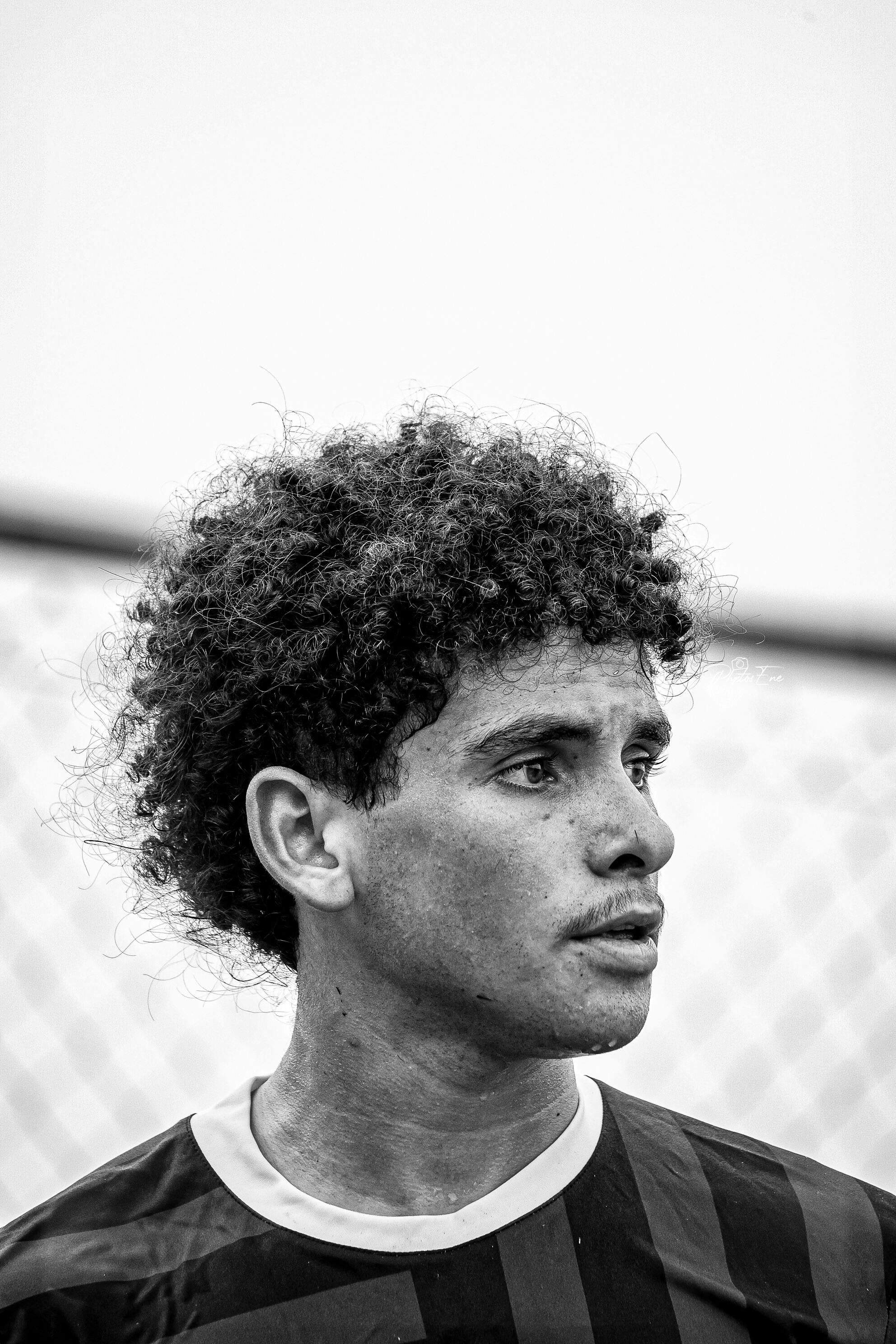 Striking black and white portrait of a young male soccer player.