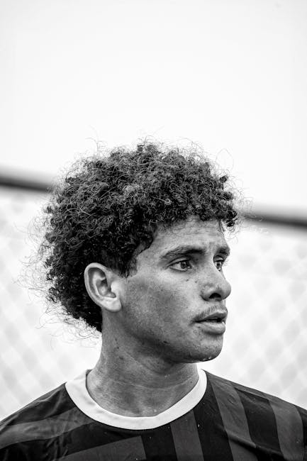 Striking black and white portrait of a young male soccer player.