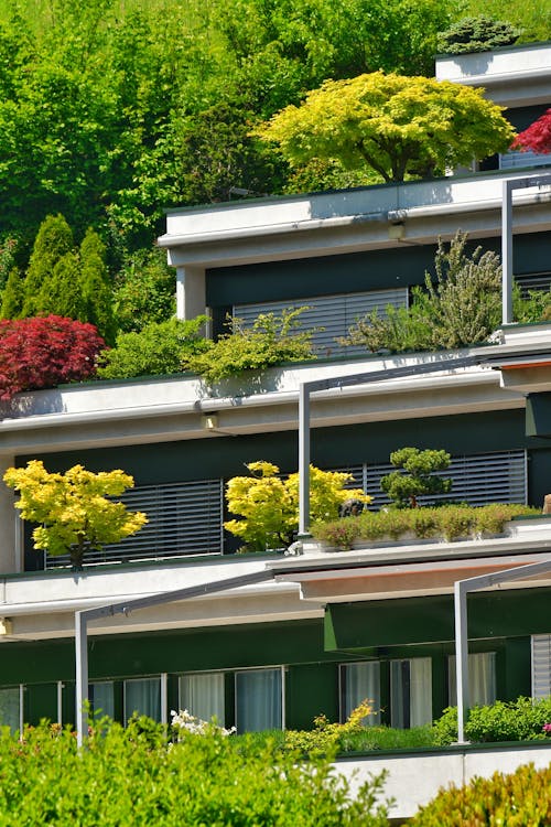 A house with plants on the roof and balconies