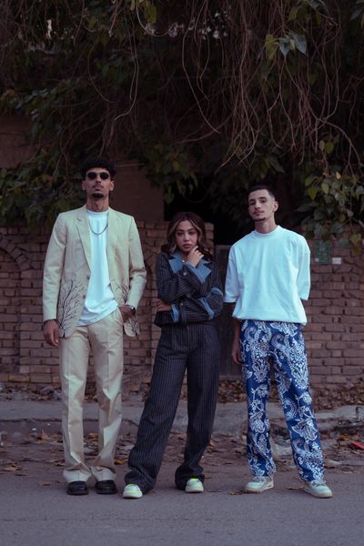 Three performers standing under trees at golden hour — khezez on Pexels