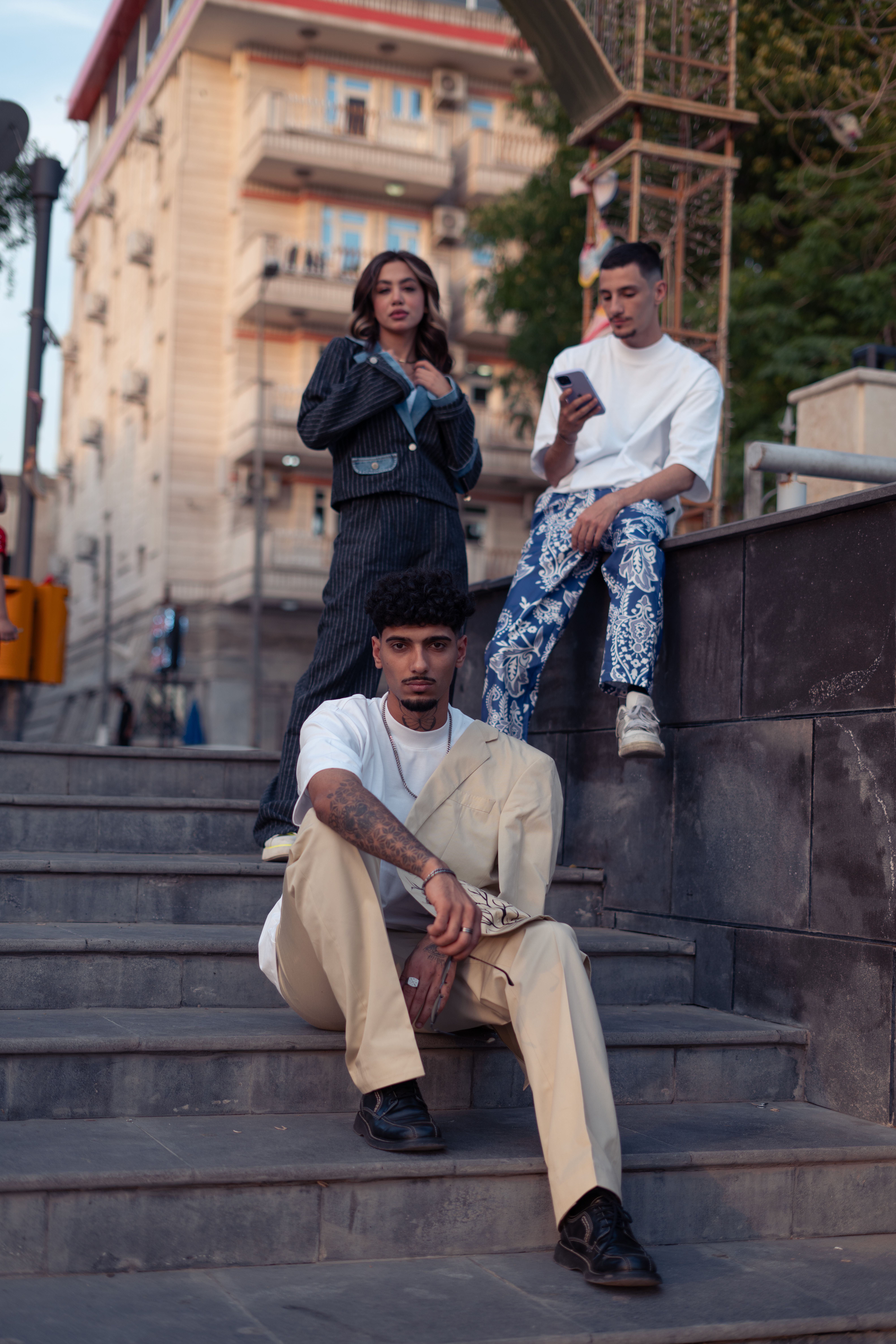 Three People Sitting on the Steps · Free Stock Photo