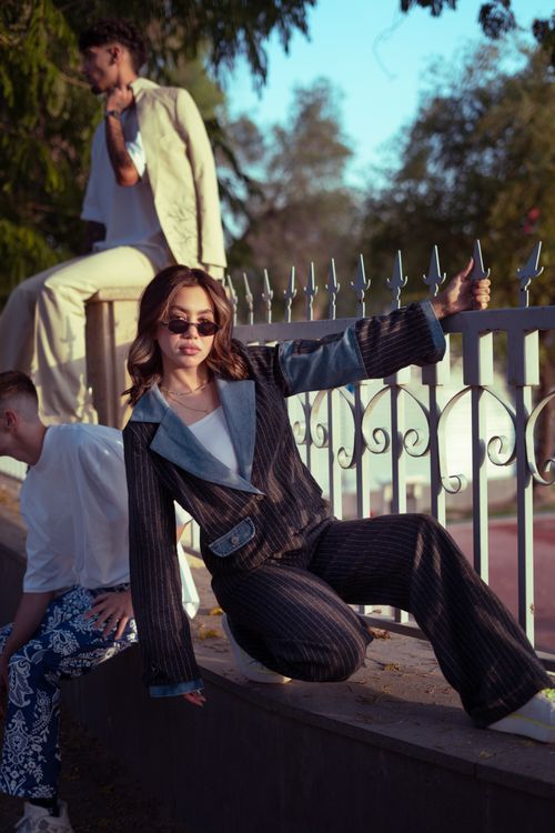 Free Trendy friends in fashionable attire pose by a bridge in Baghdad during sunset. Stock Photo