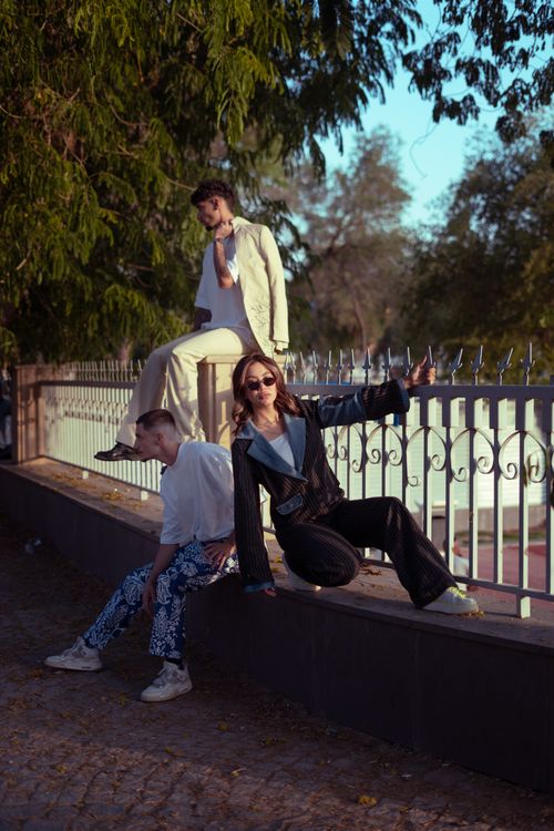 Free Stylish group poses on a bridge in Baghdad, Iraq during sunset with trees in the background. Stock Photo