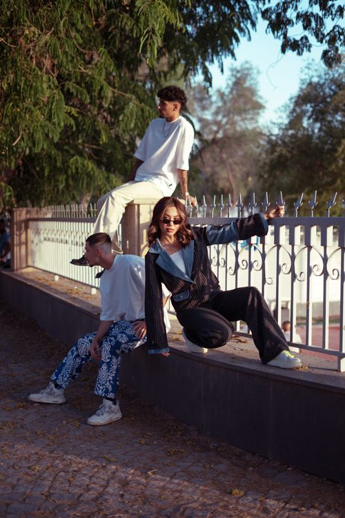 Free Young stylish friends posing by a wrought iron fence in Baghdad, Iraq. Stock Photo
