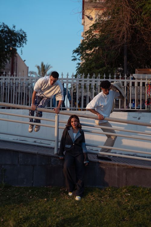 Free Stylish group enjoying a sunny day in Baghdad park, showcasing modern fashion. Stock Photo