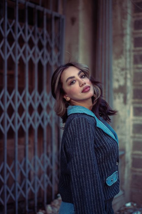 Free Portrait of a woman in a striped blazer, showcasing modern fashion in Baghdad. Stock Photo