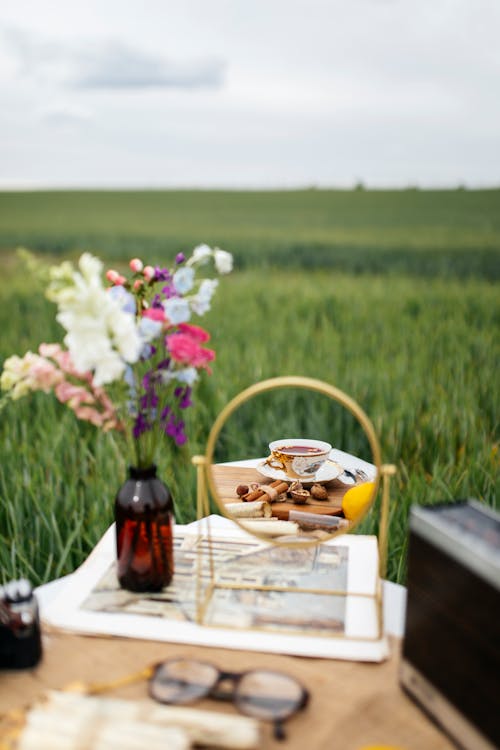 Mirror and Flowers on Table on Rural Field