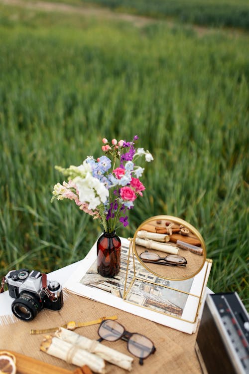 Mirror and Flowers on Table on Field