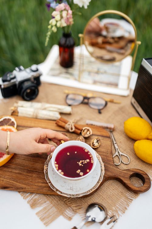 Free A vibrant picnic scene featuring tea, lemons, and vintage camera. Stock Photo