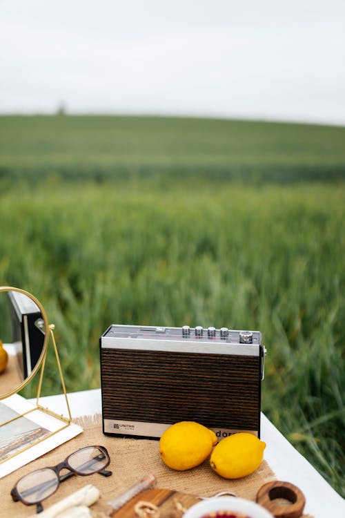 Radio and Lemons on Table on Field