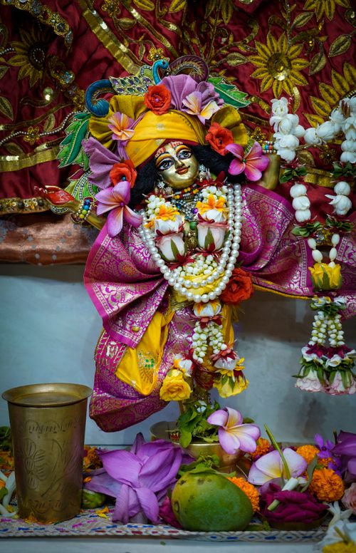 Free Colorful Hindu deity figurine adorned with flowers and religious ornaments. Stock Photo