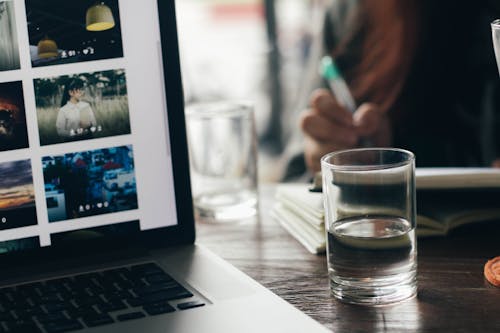 Free Drinking Glass Beside Macbook Pro Stock Photo