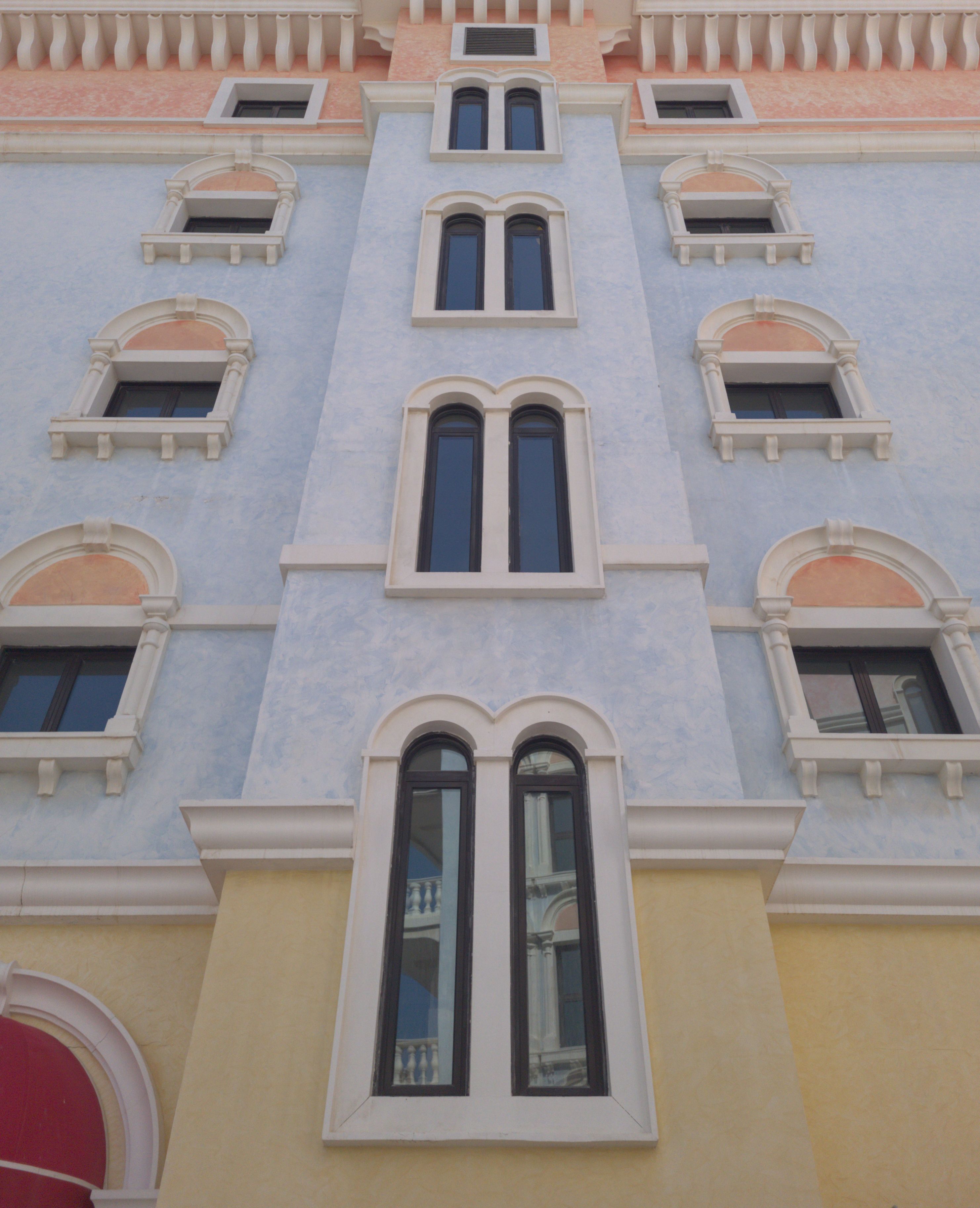 Low Angle View of a Facade of a Building With Rows of Arched Windows ...