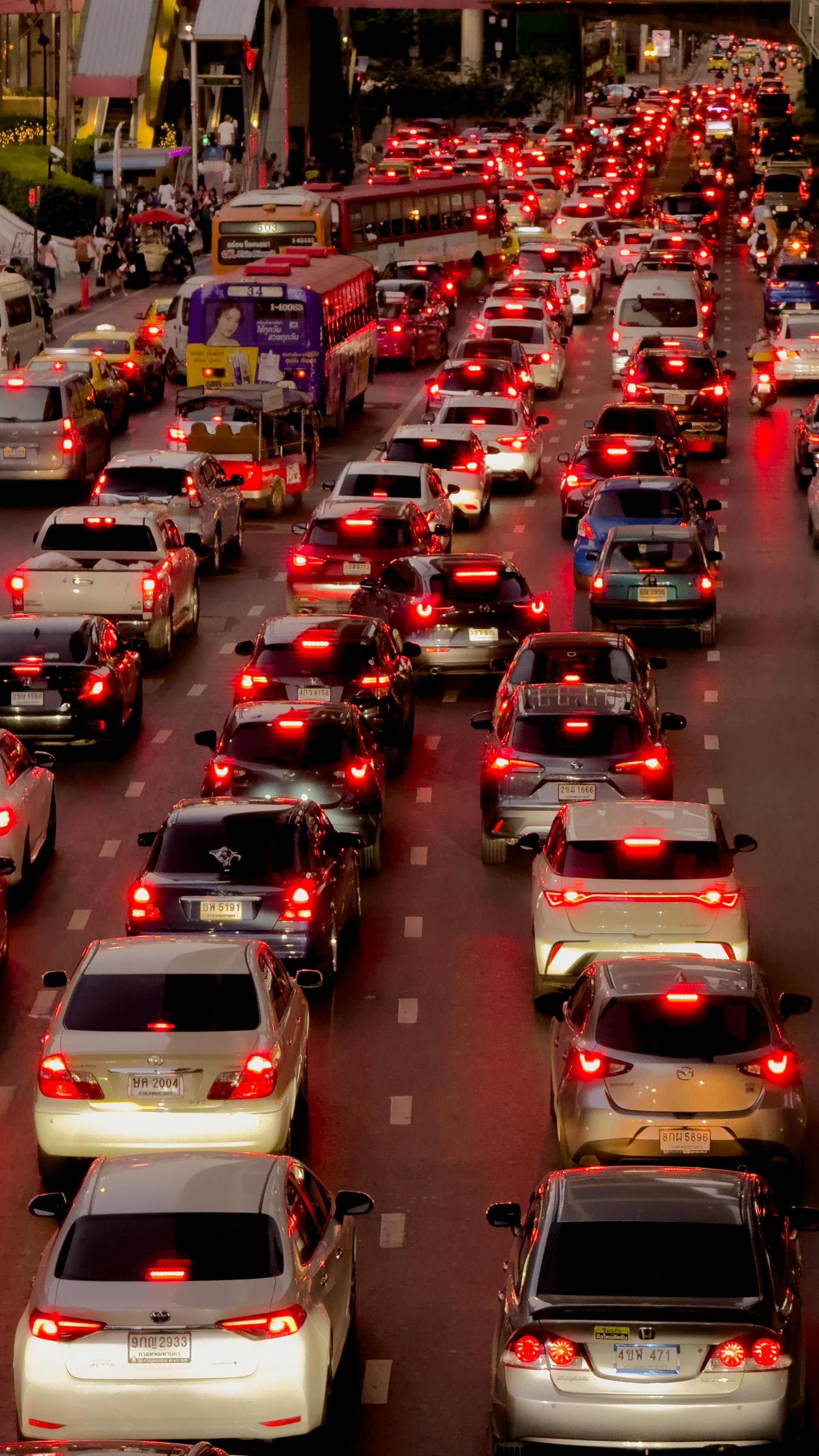 Heavy traffic jam in downtown Bangkok at twilight with numerous cars