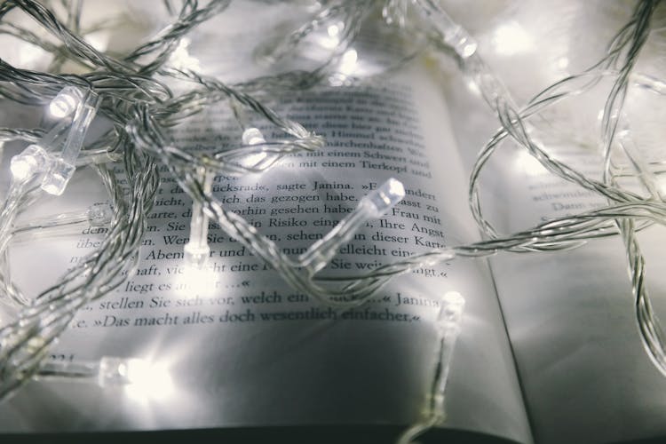 White String Lights Turned-on On Opened Book