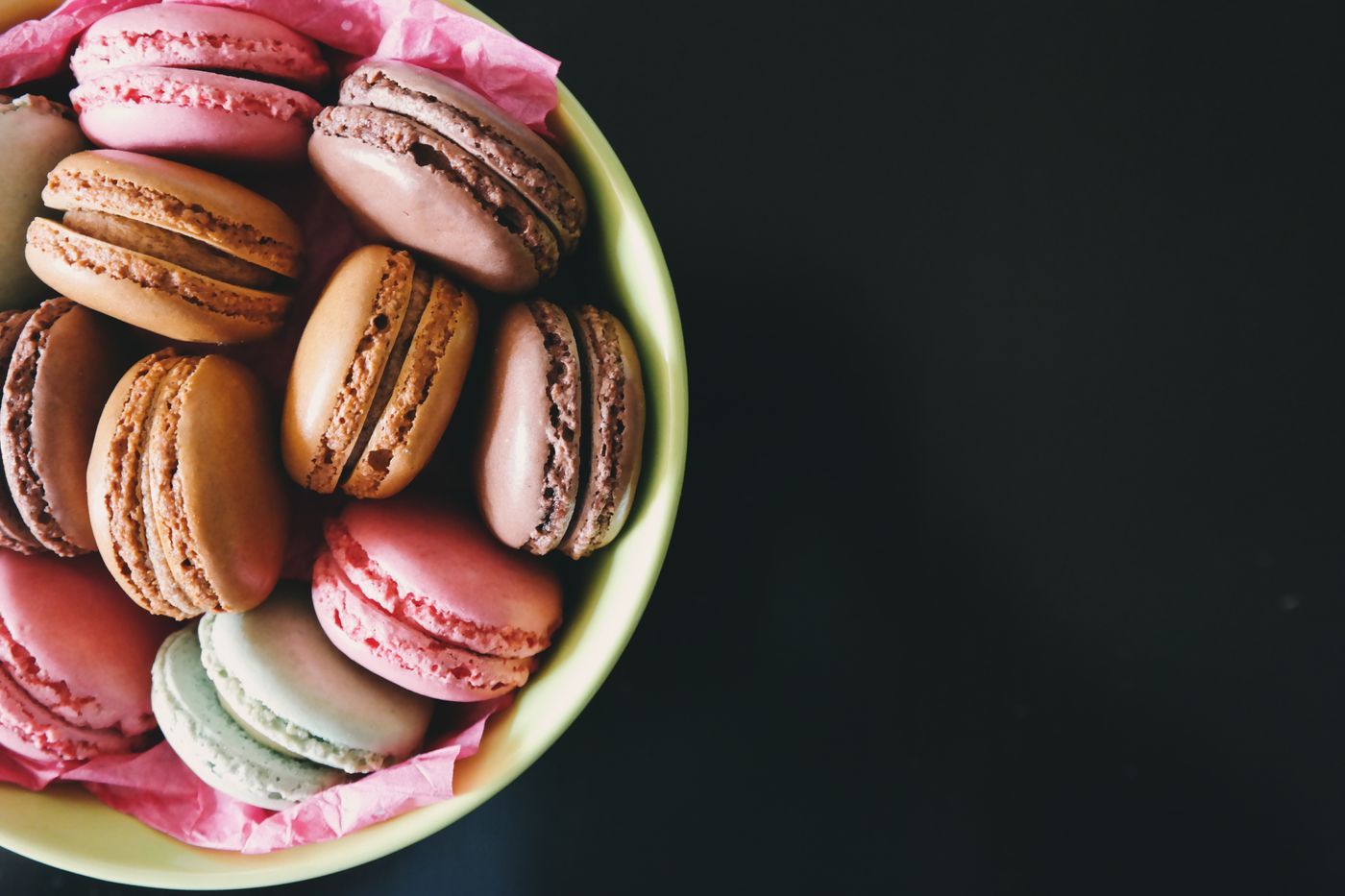A bowl of pastel macarons