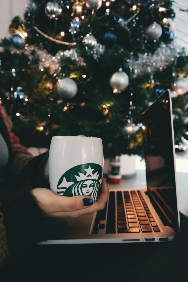 Person Holding Starbucks Mug