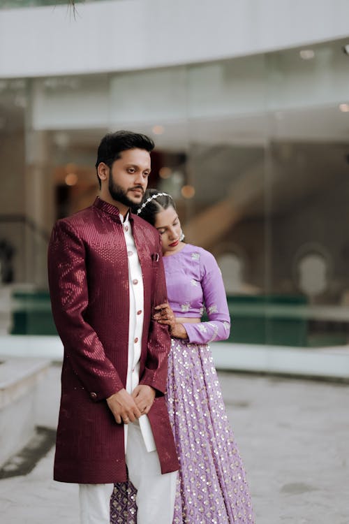 A couple in traditional indian attire pose for a photo