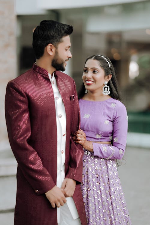 A couple in traditional indian attire posing for a photo