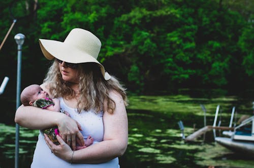 Free Photo of Woman Carrying Her Baby Stock Photo