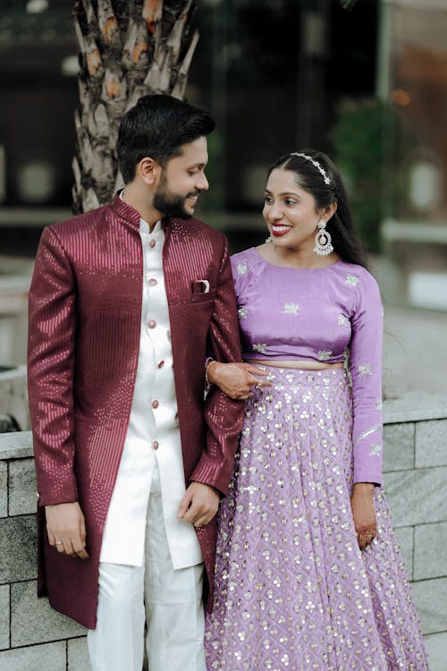 A couple in traditional indian attire posing for a photo