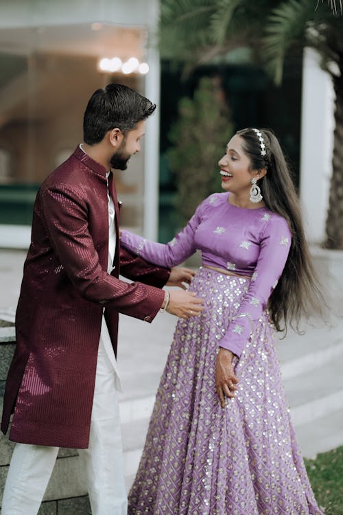 A couple in traditional attire standing next to each other