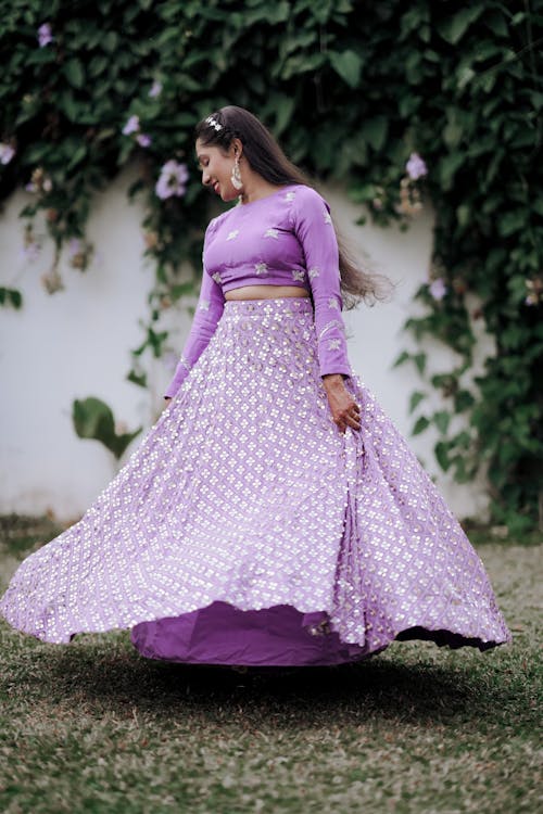 A woman in a purple lehenga with a long skirt