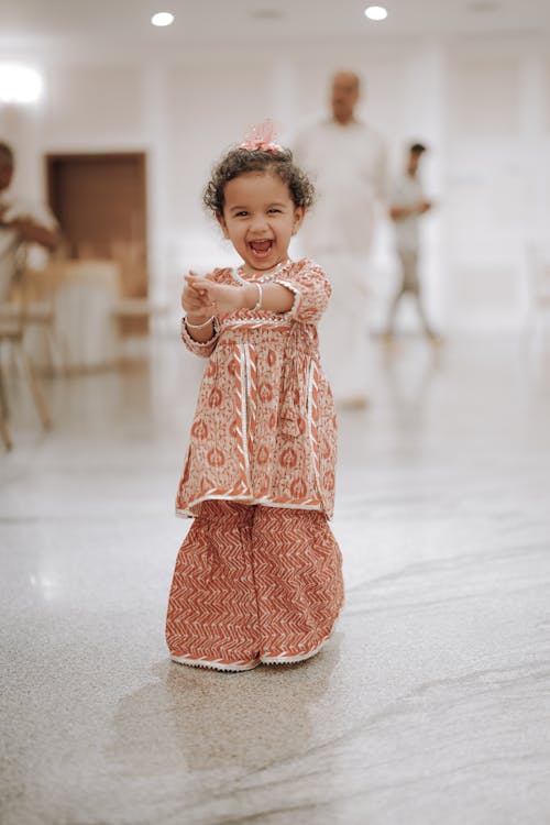 A little girl dancing in a wedding hall