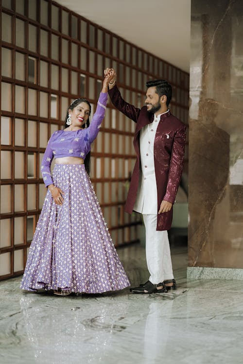 A couple in traditional attire dancing in a room