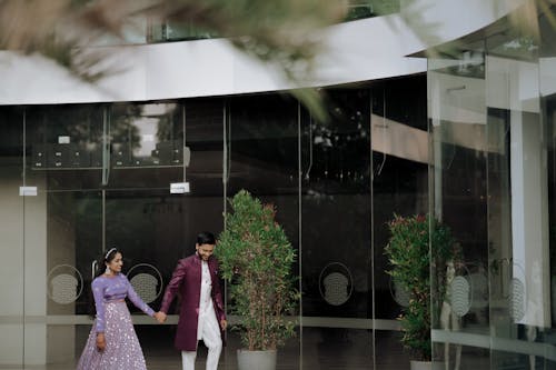 A couple walking in front of a building