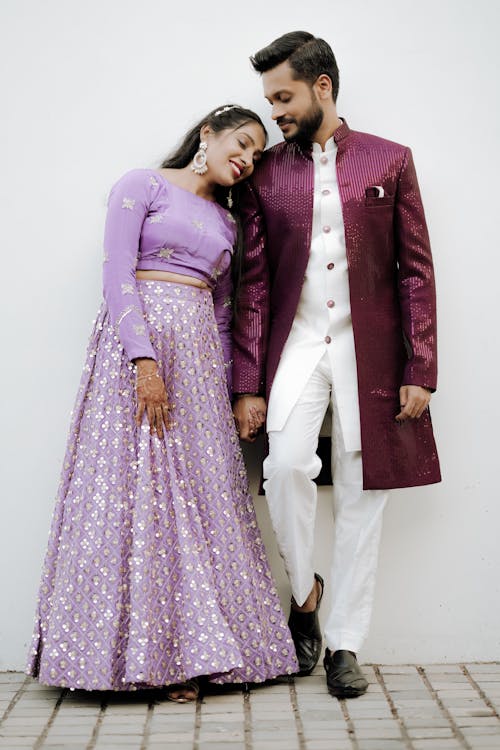 A man and woman in purple and white outfits