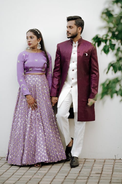 A man and woman in purple and white outfits