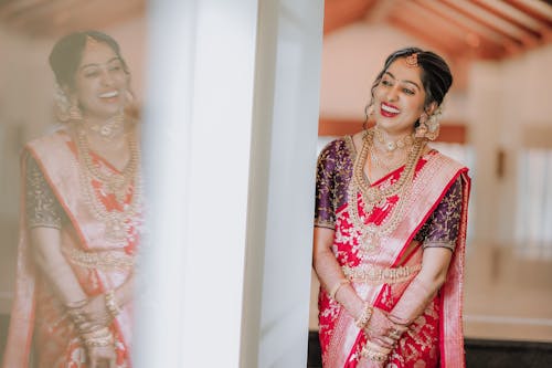 A beautiful bride in a pink sari smiling