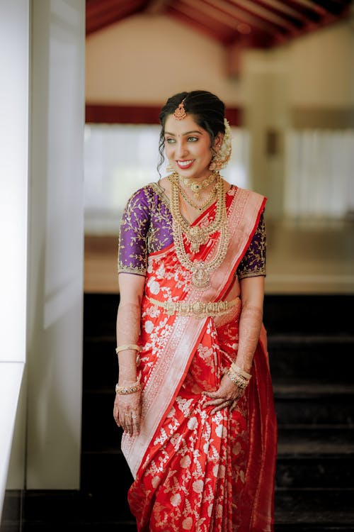 A beautiful indian bride in a red and gold sari