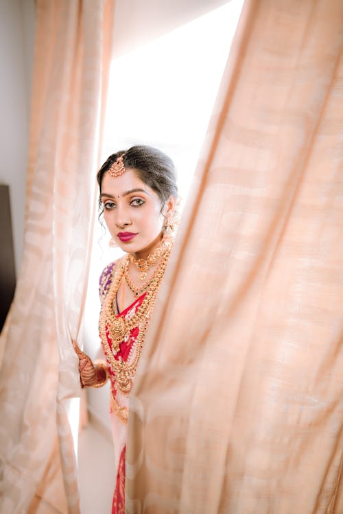 A beautiful indian bride in a red and gold sari