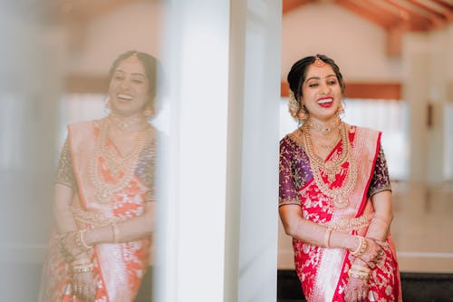A beautiful indian bride in a red and pink sari