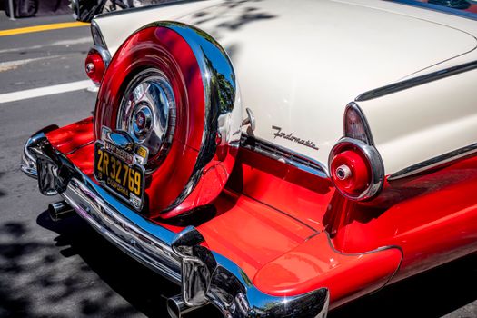 Vintage Ford Fairlane car showcasing its retro design and vibrant colors on a sunny day.