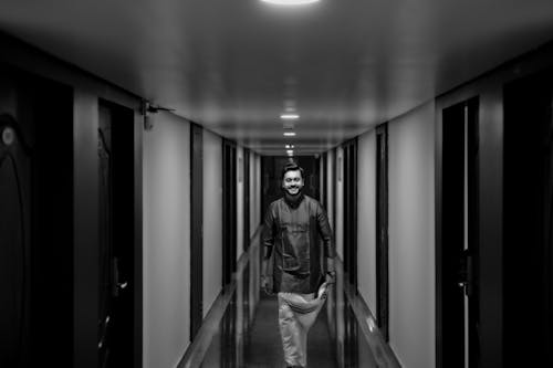 A man walking down a hallway in a hotel