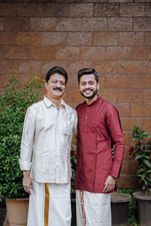 Two men in traditional indian clothing standing next to each other
