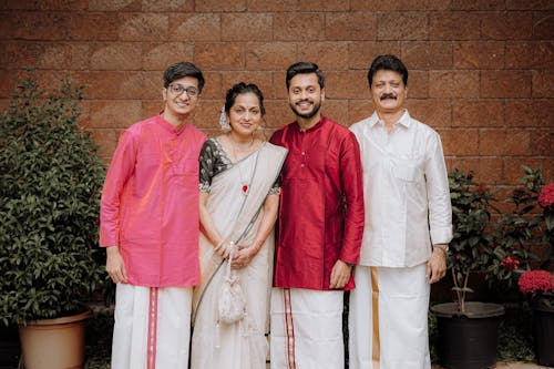 A family posing for a photo in traditional attire