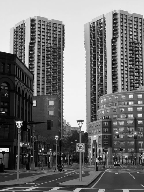 Free Black and white photo of tall city skyscrapers in an urban setting. Stock Photo