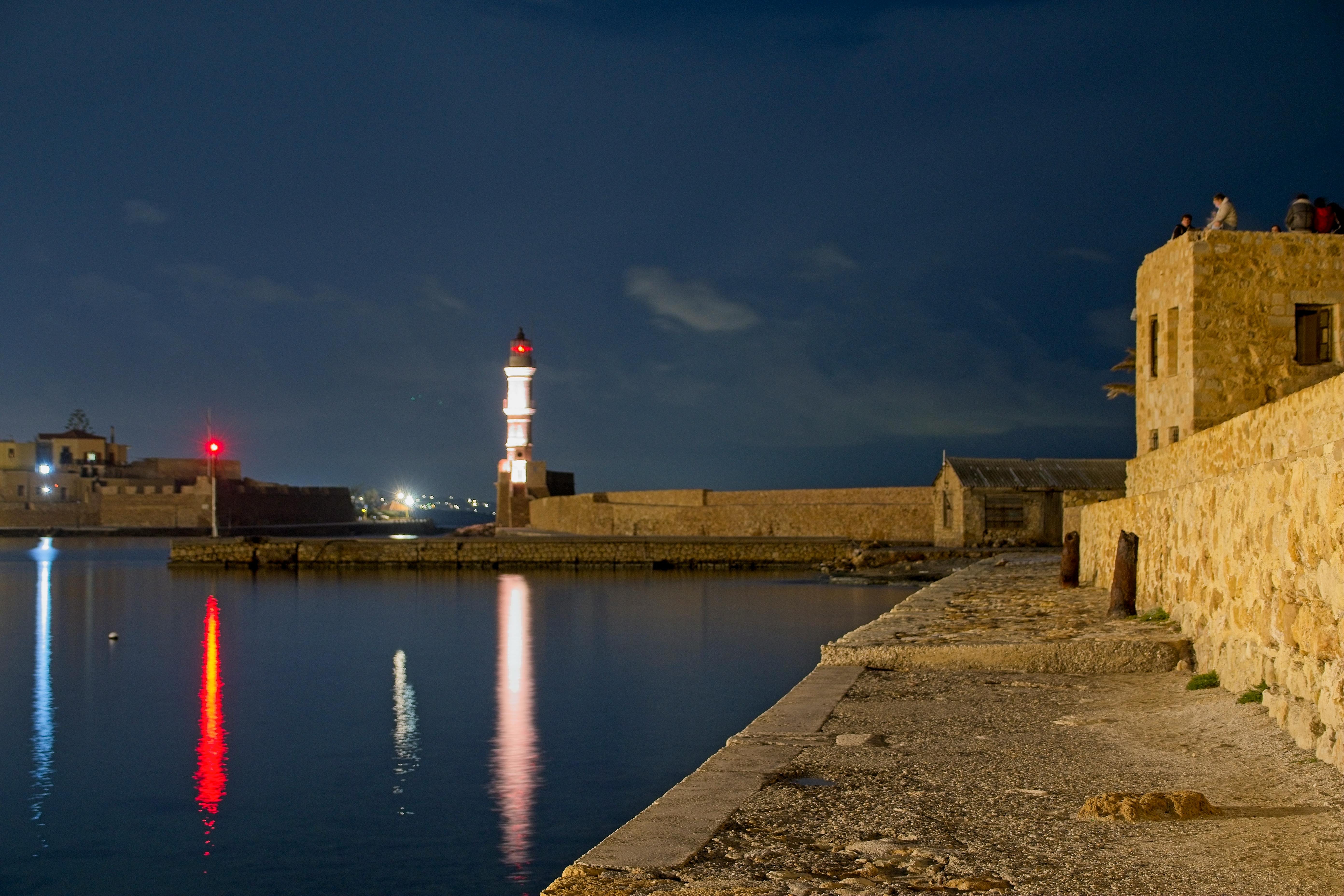 lighthouse and port of chania at dusk