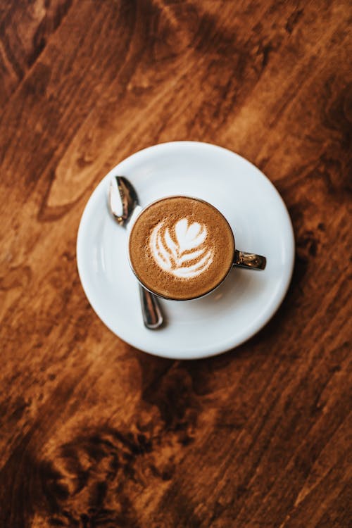 Free Cappuccino in White Ceramic Cup on White Ceramic Saucer Stock Photo