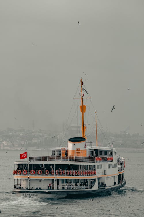 A ferry boat traveling on a cloudy day
