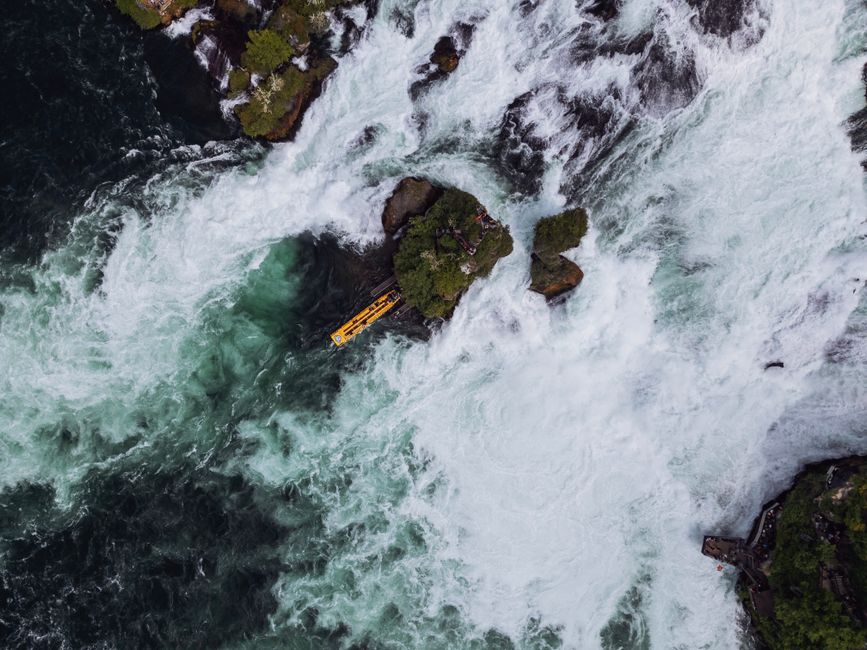 Spectacular Helicopter Scenic Flight Over Victoria Falls - 13 Minute Flight. Review: The Ultimate Flight of Angels Experience Review 2026 - Stunning aerial view of the Rhine Falls with swirling waters and a tour boat, showcasing the natural beauty of Switzerland.