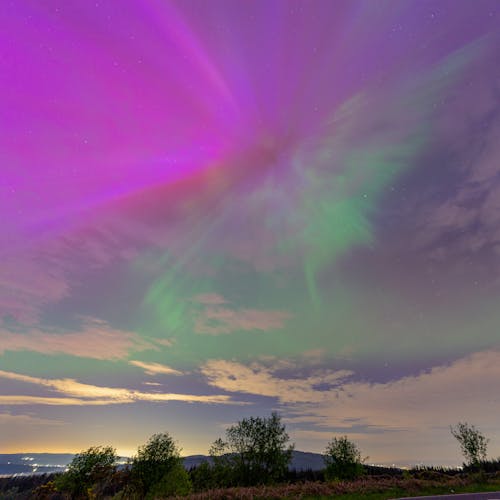 The aurora bore is seen in the sky over a road