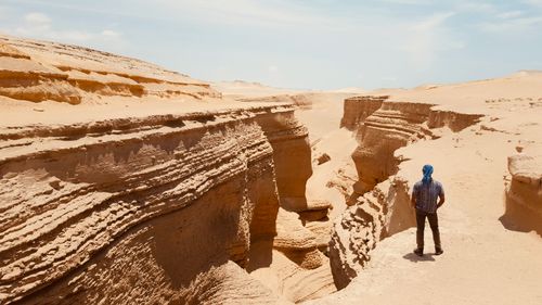 Free A solitary man gazes into the vast desert canyon in Huacachina, Peru. Stock Photo