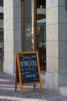 Restaurant entrance in Zürich featuring a sign advertising spare ribs promotions.